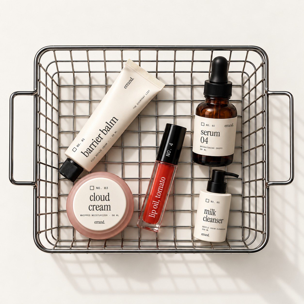 A wire shopping basket holding five labeled errand. skincare products