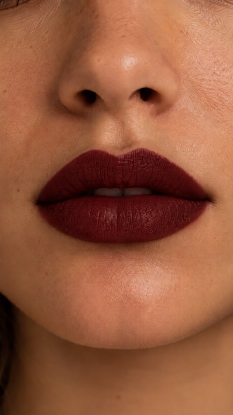 The same close-up, lips now in deep oxblood